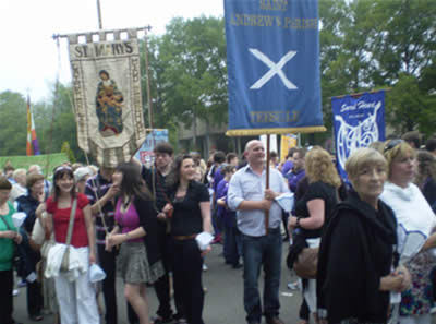 The parish banner is carried proudly by parishoners