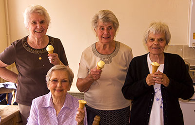 The tea ladies enjoy an ice cream at the end of the fair.