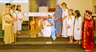 Young people perform the Live Bethlehem scene before the First Mass of Christmas on Christmas Eve