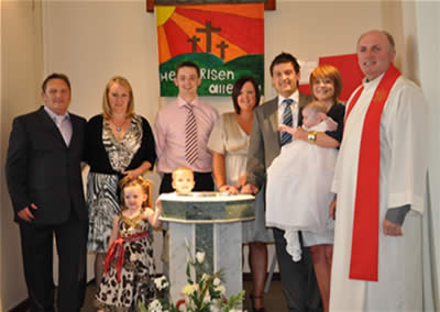 Paul Shell and Grin Cavahagh pictured with God parents after their daughters Baptism.